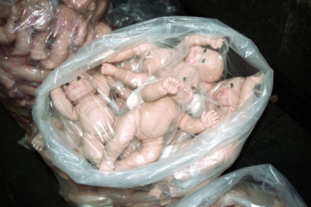 Plastic bag full of baby dolls
