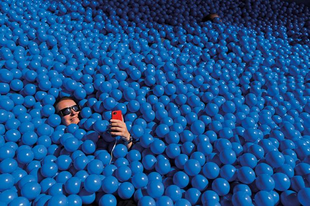 Person taking a selfie in a ball pit