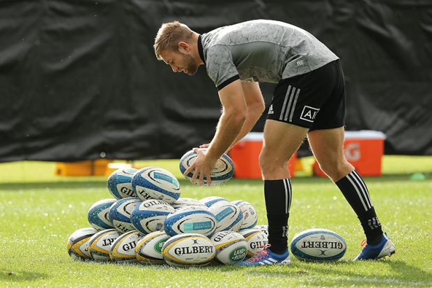 rugby player with pile of balls
