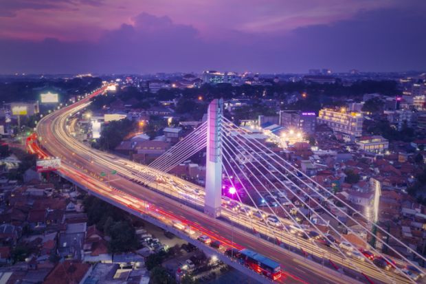  Aerial view of glowing Pasupati overpass at evening in Bandung city