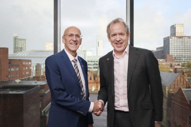 Vice-chancellors of Manchester universities shaking hands. 