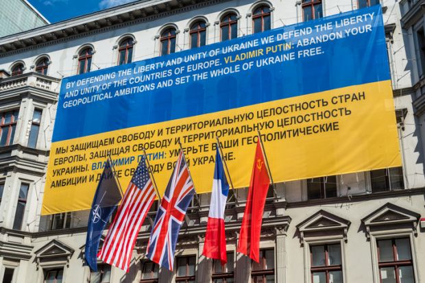 Berlin, Germany - May 28, 2017 Flags of Ukraine, NATO, USA, UK, France, former USSR on the wall of the Haus am Checkpoint Charlie museum as solidarity with Ukraine in Berlin, Germany.