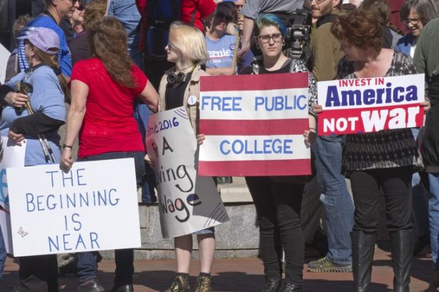 Bernie Sanders supporters with a free college sign