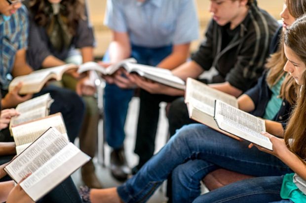A group of students read the bible A group of students read the bible