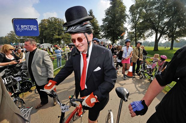 Man wearing suit and bowler hat on a bicycle