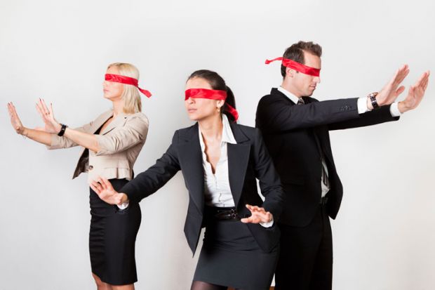 Blindfolded business people holding arms out Blindfolded business people holding arms out