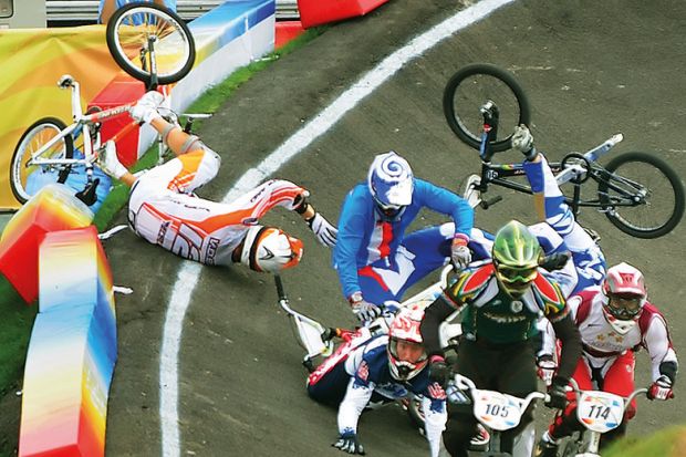 Group of BMX riders fall during race