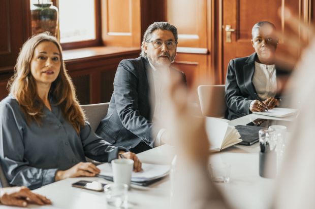 Board members listen to someone speaking Board members listen to someone speaking