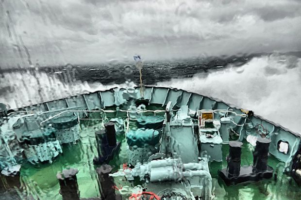 A boat in a storm, representing academic freedom