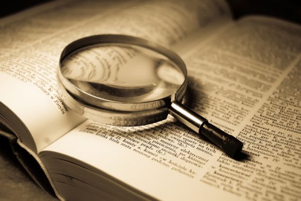 A magnifying glass on a book