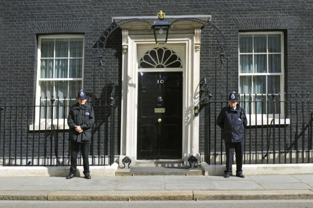 British police officers guarding 10 Downing Street entrance, London
