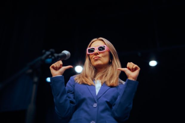 A woman in pink glases points to herself, illustrating showing off on socail media