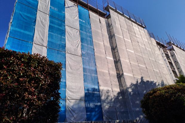 Building restoration with scaffolding, maintenance of residential apartments
