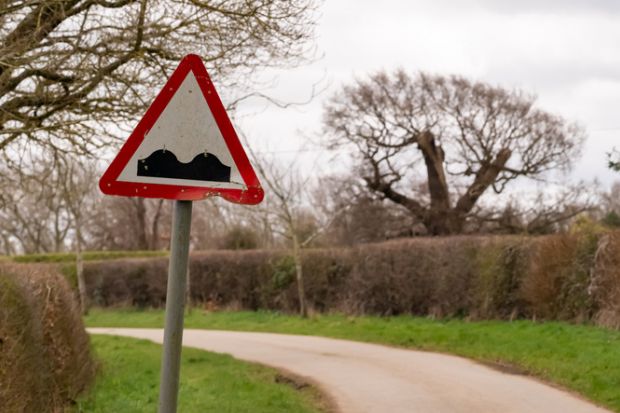 Bumpy road road sign on a narrow country lane