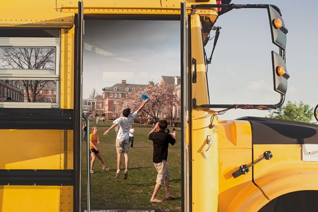 University students framed by school bus door