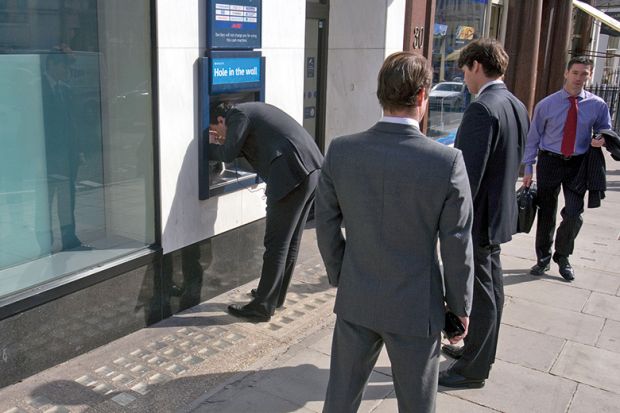 Business men at ATM
