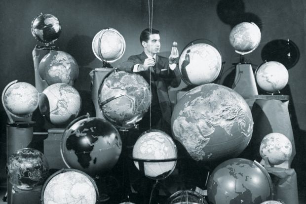 Businessman surrounded by globes of the world