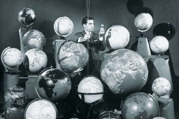 Businessman surrounded by globes of the world Businessman surrounded by globes of the world