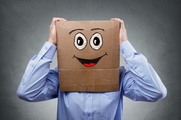 Businessman with smiley face cardboard box on his head