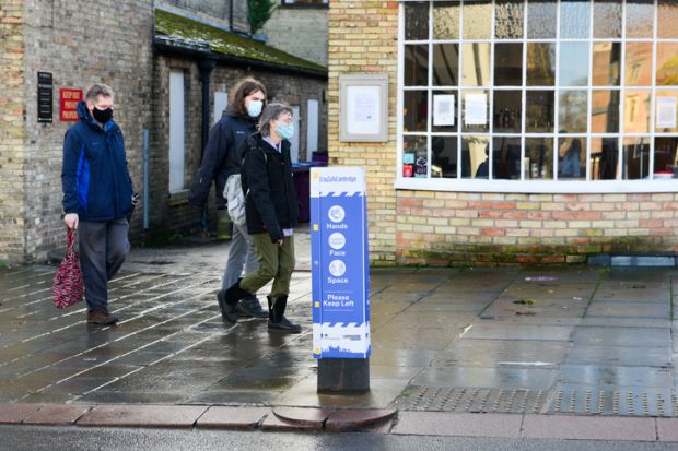 Cambridge, UK, 19-12-2020. Signage on public path advising people to keep distance whilst out shopping,