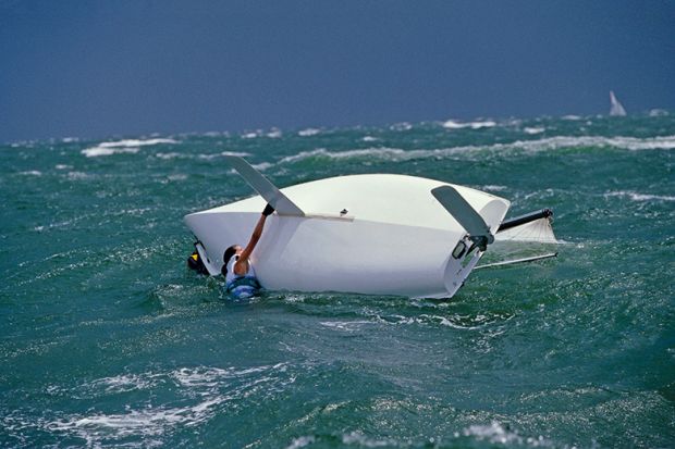 Capsized woman and boat