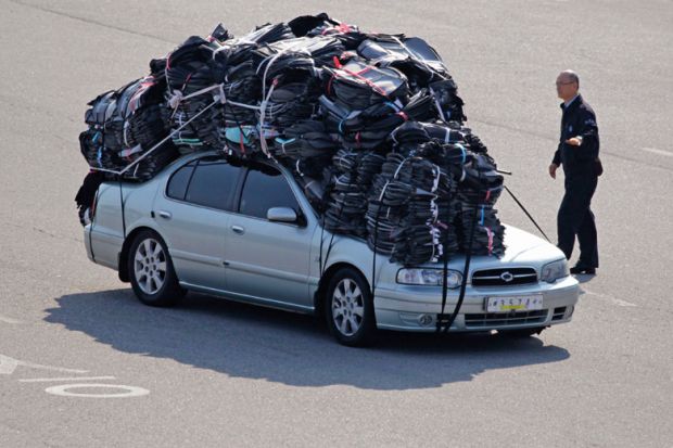 Car covered in heavy baggage