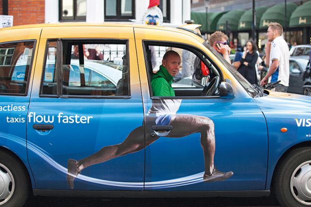 Taxi cab with advertisement on the side that adds body to driver's head, humorously