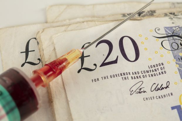 a syringe with a £20 note