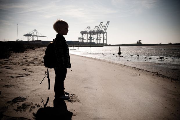 A child standing on a beach
