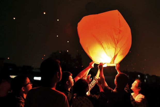 Chinese students releasing paper lanterns