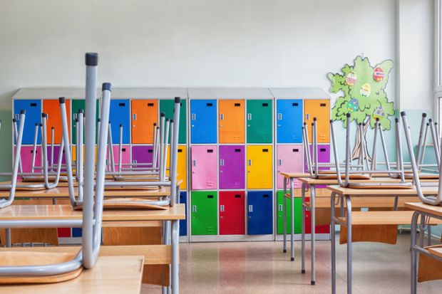 Classroom with colorful lockers and raised chairs on the tables