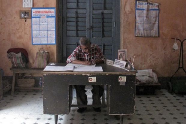 A clerk sits at his desk