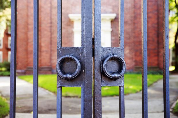 Locked gate illustrating news article about record low UK dropout rates among university students