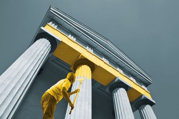 Man paints columns yellow