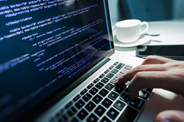 Computer programmer coding on laptop Computer programmer coding on laptop