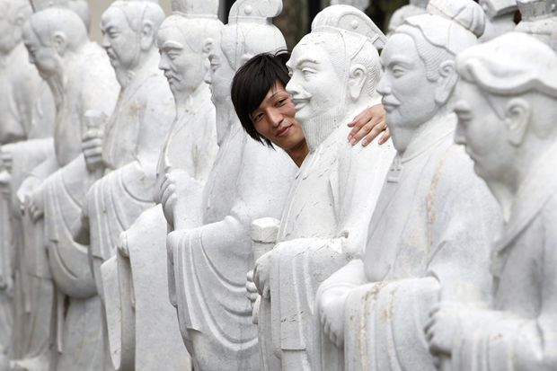  A visitor looks at the statues of Chinese sages, the 72 Disciples of Confucius, in the courtyard at the Koshi-byo, or Confucius Shrine, which also houses the Historical Museum of China, in Nagasaki, Japan