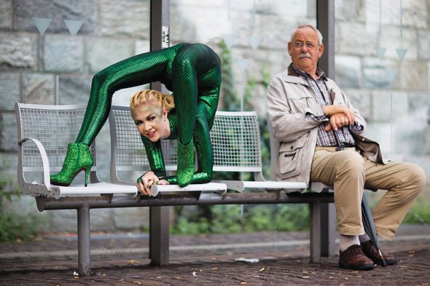 Contortionist next to an older man on a bench illustrating flexibility of young universities