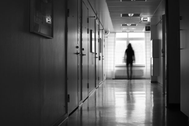 A woman leaving a corridor