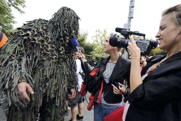 A raver is interviewed by a local TV crew during the 19th annual Techno Street Parade in Zurich
