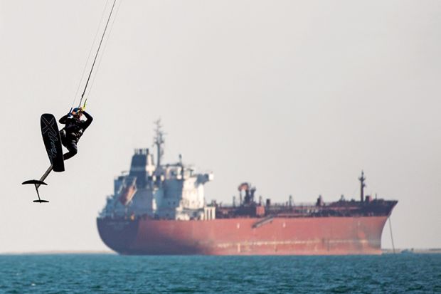 Kite surfer with tanker in the background