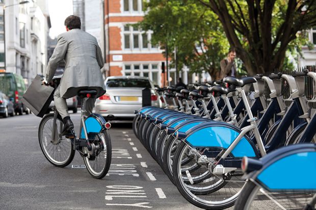 Man in suit rides Boris bike (Santander cycle) in London Man in suit rides Boris bike (Santander cycle) in London