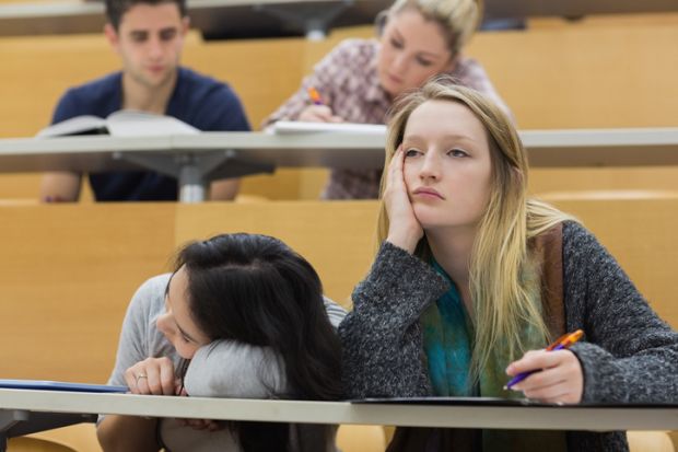 Demotivated students sitting in a lecture hall