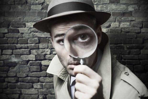 Private detective with magnifying glass