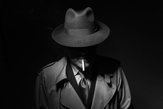 A film noir detective with face in shadow, symbolising the necessity of subterfuge