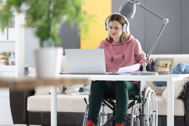 A disabled student working at home