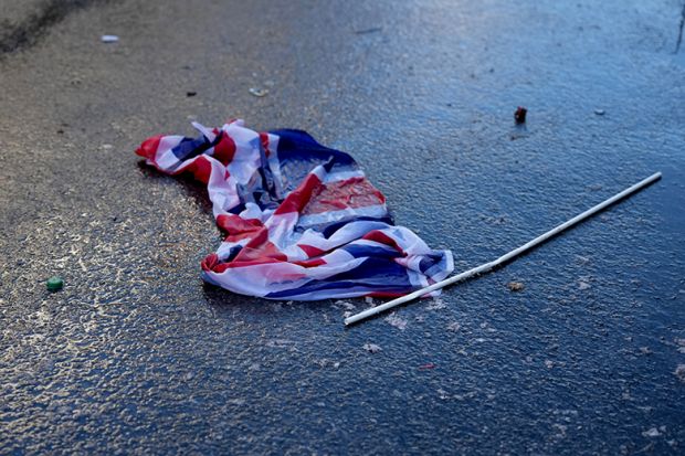 A Union Jack flag is seen discarded on the ground, to illustrate Whitehall cuts ‘undermining’ international education expansion.