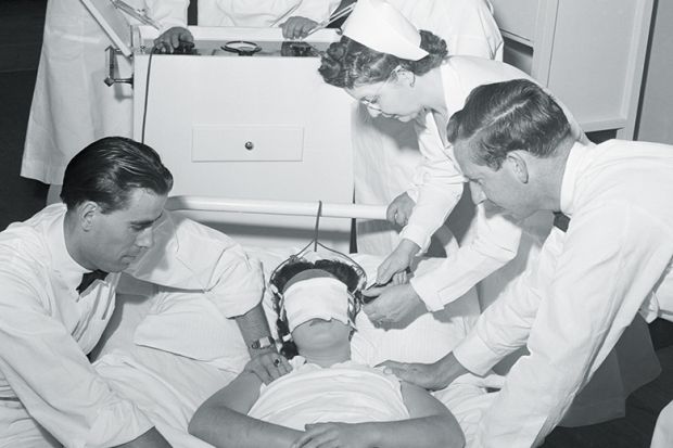 doctors administering electroshock therapy