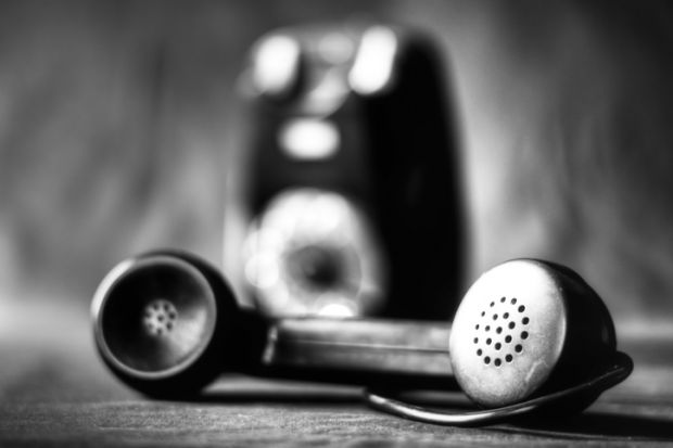 An old-fashioned phone in black and white