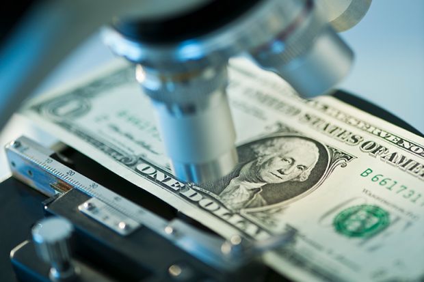 Dollar bill under microscope to illustrate research funding