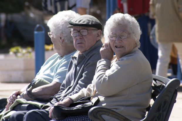 Elderly man and women sitting on bench